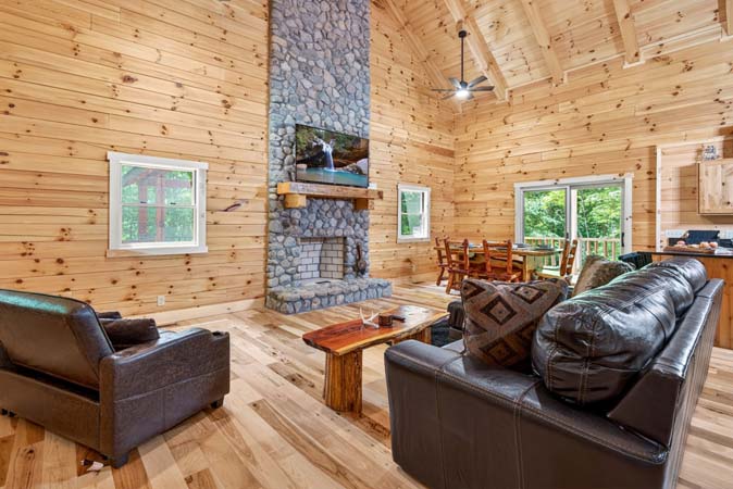 Covered deck with outdoor dining at Happy Hours Cabin