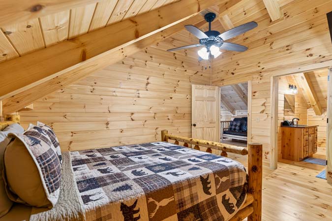 Primary bedroom with queen bed at Happy Hours Cabin