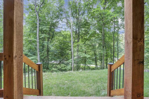 Shagbark Hickory Ridge, Hocking Hills — upper porch with rocking chairs along the log wall