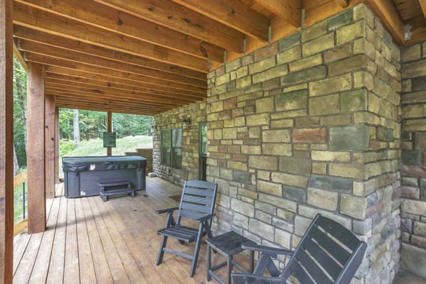 Shagbark Hickory Ridge, Hocking Hills — view between deck posts to the lawn and treeline