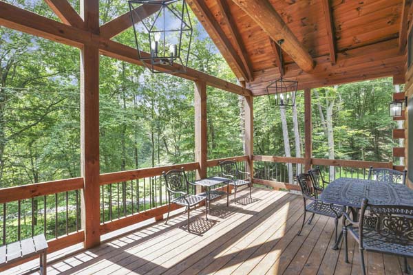 Shagbark Hickory Ridge, Hocking Hills — wide covered deck with lantern lighting and seating