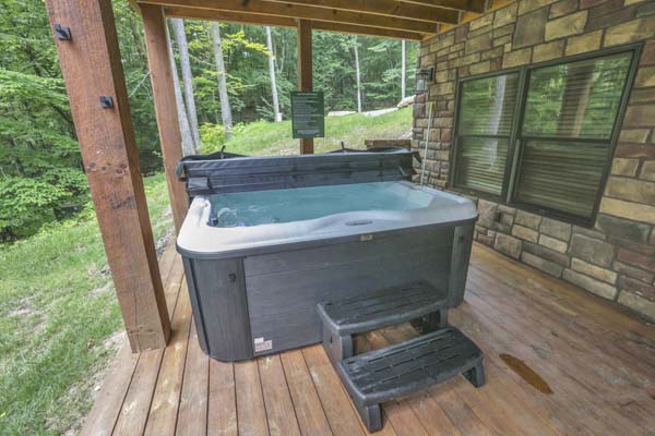 Shagbark Hickory Ridge, Hocking Hills — outdoor stone fireplace with a fire burning